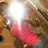 A pixelated static image shows a bright white light source with a pinkish-red gradient extending downward, set against a brown and beige background with scattered dark and light patches.