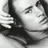 Pixelated grayscale image of a person's face with closed eyes, dark hair, and a neutral expression, cropped to show only the upper portion of the head.