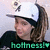 Pixelated image of a person wearing a white cap with dark brim, long brown hair, and black top; green text 'hollness!' at bottom.