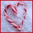 A pixelated heart-shaped icon with red and pink tones on a light blue background, bordered by a solid red frame.