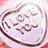 A circular icon with a light purple background and dark brown border, featuring stylized text in the center.