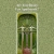 A static pixelated image of a vertical rectangular frame with a light border, containing layered green and brown shapes resembling a stylized plant or abstract structure against a muted green background.