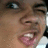 Pixelated close-up of a person's face showing eyes, nose, mouth with pink lips and visible teeth.