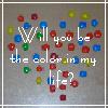 Pixelated text reads 'Will you be the color in my life?' over a gray background with scattered colored squares.