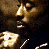 A 2x2 contact sheet of a pixelated animated icon featuring Tupac Shakur with yellow and gray background sections containing text elements.