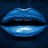 Pixelated blue lips with a glossy highlight on the lower lip against a dark background, accompanied by blue text reading LUCKY FOR LIFE and CHARMS.