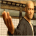 A person in dark clothing performs a hand gesture with fingers extended, set against a -patterned background with horizontal bars