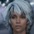 Pixelated close-up of a person with light blue hair and dark eyebrows against a blurred background with light blue and white tones.