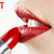 A close-up of a person's mouth applying red lipstick with a silver tube, showing sequential text changes from 'T' to 'Tos' to 'Tosh' to 'Tosh'
