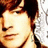 Pixelated close-up of a person's face with brown hair, light skin tone, and closed eyes against a white background.