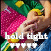 A static image shows two hands clasped over a pink polka-dot fabric, with 'hold tight' text and five white hearts below.
