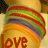 Animated contact sheet showing two frames of a rainbow-striped circular icon with the word "love" in different colors on a yellow background.