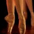 A static pixelated image showing vertical brown and orange stripes with dark gaps against a black background.