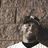 Pixelated image of a person in a dark hat and white shirt against a brown background, with blue text reading 'Back Off Hes Mine' on the right.