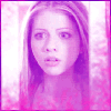 A static image of a person with long light brown hair and a pink-toned background, displayed in a