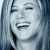 Pixelated close-up of a person with light hair, closed eyes, and an open mouth showing teeth in a smiling expression against a blue-toned background.