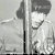 Black-and-white animated sequence showing a person in military-style uniform with dark hair, viewed through vertical bars from multiple angles.