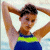 A split-frame contact sheet showing a woman in a blue swimsuit on the left and green text reading "Original Icons .com" on the right, with visible pixelation and dithering effects.