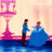 Pixelated scene with two figures: a standing person in blue shirt and brown pants, and a seated figure in large blue dress, near pink hourglass structure on water.