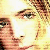 Pixelated close-up of a person's face with light brown hair, visible eye, and partial mouth against a bright yellow background.