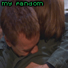 A static image of two people embracing, with green text reading "my fandom" and "doesn't leave its people behind" overlaid on the image.