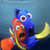 Pixelated static image of two cartoon fish characters from Finding Nemo, one blue and one orange, positioned closely together against a gradient background.