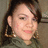 A person with dark hair and large hoop earrings wears a green top, shown in four with slight variations in head position and background