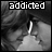 A black-and-white animated contact sheet showing two frames of a kissing couple with the word 'addicted' displayed above them.