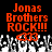 Red pixelated text "Jonas Brothers ROCK!!!" above a crowd of raised hands on black background.