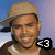 A pixelated image of a person wearing a beige cap and brown jacket with text overlays on blue backgrounds.