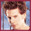 Four pixelated show a person with brown hair in various poses against a blue sky background, wearing a red shirt