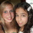 Two people with light skin tones and dark hair pose closely together in a pixelated static image with warm brown and beige tones.