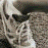 A 4-frame contact sheet of a grayscale animated icon showing a running figure with text appearing across frames.