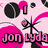Pixelated icon with pink, black, and white elements including a microphone, stylized text, and abstract shapes.