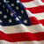 American flag with stars and stripes, white eagle on blue background, green fireworks over water.