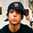 A 48x48 pixel buddy icon featuring a person in a black cap and shirt with a pink logo, shown across two frames of an animation on a contact sheet layout with a gray background.