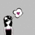 Pixelated character with black hair and white face wears dark dress with purple band; thought bubble contains pink heart; three views show varying head position and spacing.