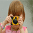 A pixelated image of a person with brown hair holding a yellow and black camera, surrounded by pink text reading "HE DONT NEED KODAK... HE CAN CAPTURE THE PIC IN OUR ❤️ HEARTS".