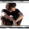 A person in a black t-shirt with a white skull graphic and brown pants crouches against a white background with scattered black stars, shown in a sequence of four