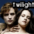 Two people with light skin and brown hair embrace against a dark blue background, one wearing a white top.