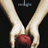 Two hands hold a red apple against a black background with white text above.