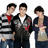 Three young men stand side-by-side against a white background, wearing casual clothing with red accents.