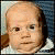 Four identical pixelated baby faces in a , each with light skin, dark eyes, and a white collar against a blue background