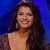 Static 50x50 pixel icon showing a person with long dark hair against a blue background, wearing an off-shoulder top and large earrings.