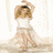 A woman in a white dress with long brown hair appears in two showing arm movement