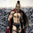 Pixelated figure in Spartan armor with red cape stands against rocky background, yellow displays text