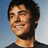 A pixelated image of a person with short dark hair wearing a dark shirt against a light blue background, with pink text reading "Mee" and "Smile!!" below and "Zac Makes" above.