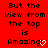 Red background with black pixelated text reading "But the view from the top is Amazing!" and a white heart symbol replacing the exclamation mark.
