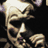 Pixelated static image of a stylized human skull with glowing highlights against dark background, rendered in low-resolution 48x48 icon format.