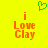 Yellow background with green pixelated heart above orange text reading 'i Love Clay' in two identical side-by-side arrangements.